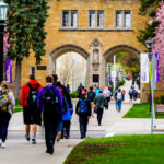 Students walk past the Arches.