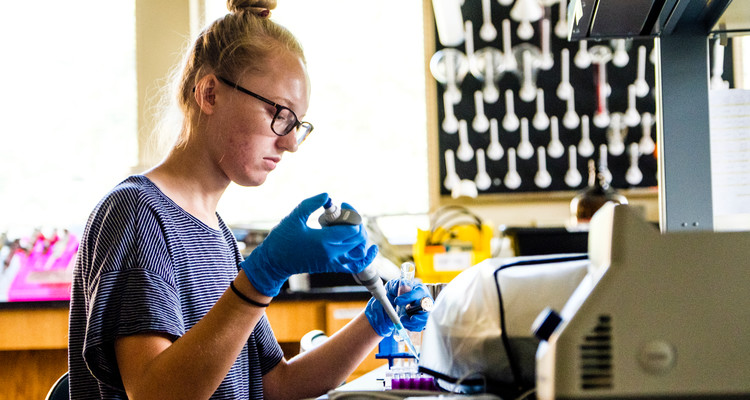 Biochemistry student Kelly DeBoom pipettes material into a vial August 1, 2016 in Owens Science Hall. Taken for CAS Spotlight magazine. Photo by Mike Ekern.