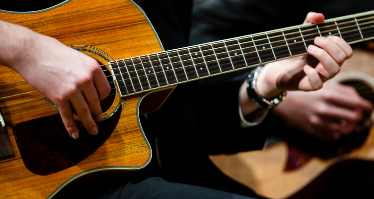 Hands on a guitar are show as the guitar ensemble performs during a dress rehearsal for the St. Thomas Christmas Concert December 6, 2015 at Orchestra Hall in Minneapolis.