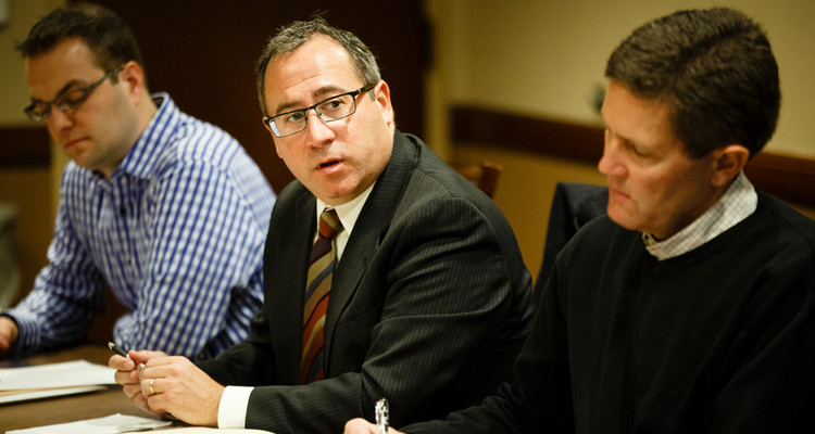 Board member Gino Lambo, middle, speaks during a Catholic Studies Advisory Board meeting at Terrence Murphy Hall on the Minneapolis campus on January 12, 2015. Board member Chris DuFresne is pictured to the far left and board member Joeseph Lahti is pictured to the right.