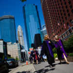 A new School of Law graduate (right) walks away from the Minneapolis Hilton with professor Julie Oseid following the School of Law Commencement ceremony May 13, 2017.