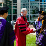 School of Law dean Robert Vischer greets new graduates following the School of Law Commencement ceremony May 13, 2017 at the School of Law.