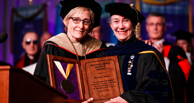 President Dr. Julie Sullivan poses for a photo with outgoing Dean of the School of Social Work Barbara Shank after she was presented with the Distinguished Service Award at the 2017 Graduate Commencement ceremony in the Anderson Athletic and Recreation Complex in St. Paul on May 20, 2017.