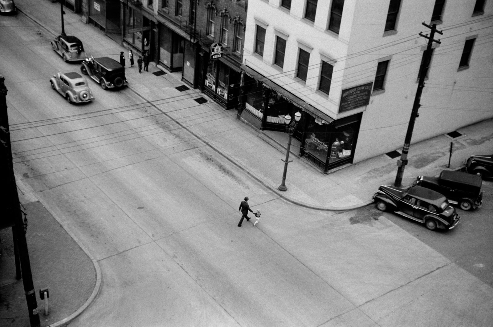 Man and boy crossing the street, Dubuque, Iowa 1940