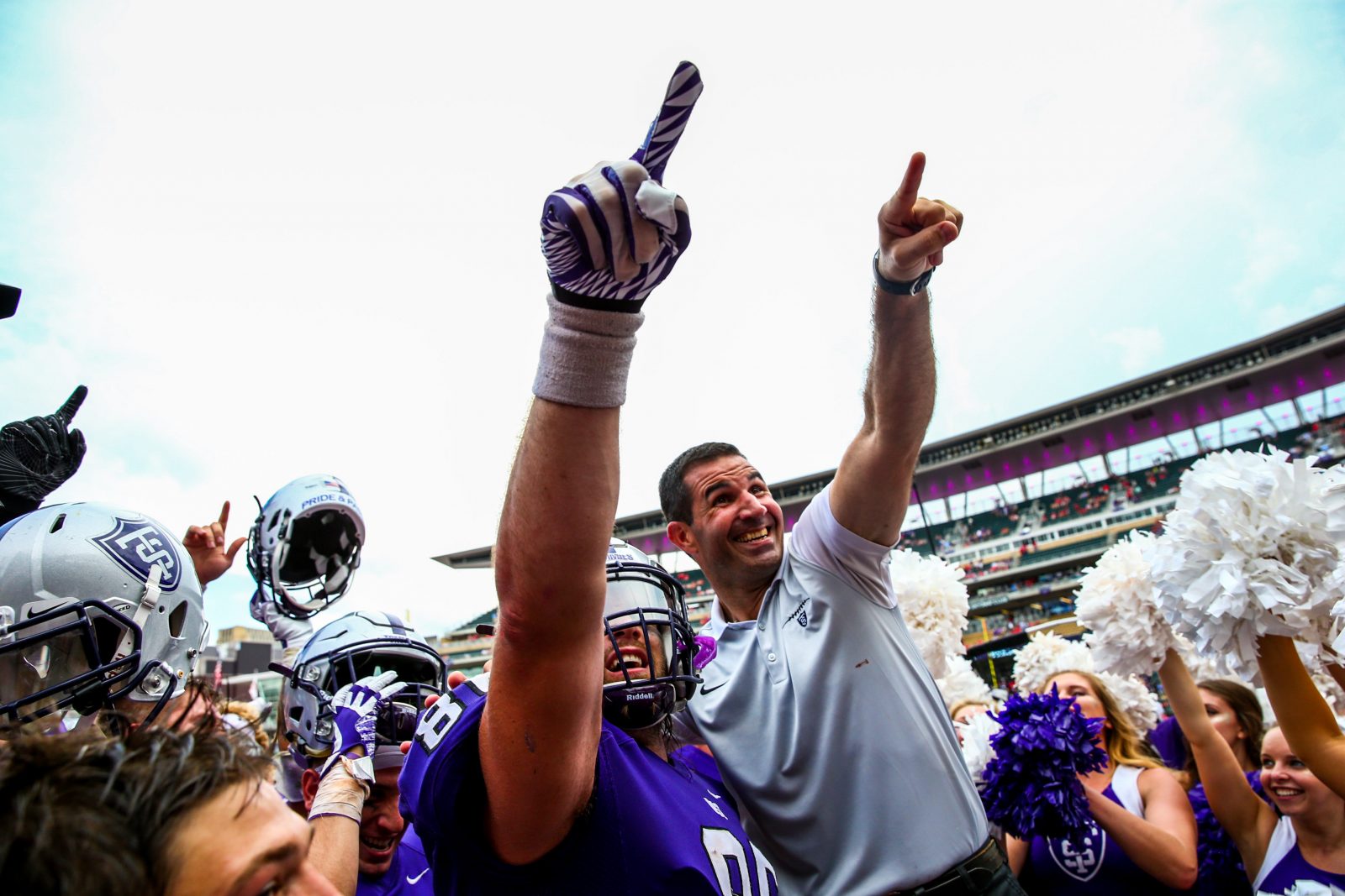Coach Glenn Caruso and the Tommies celebrate their victory.