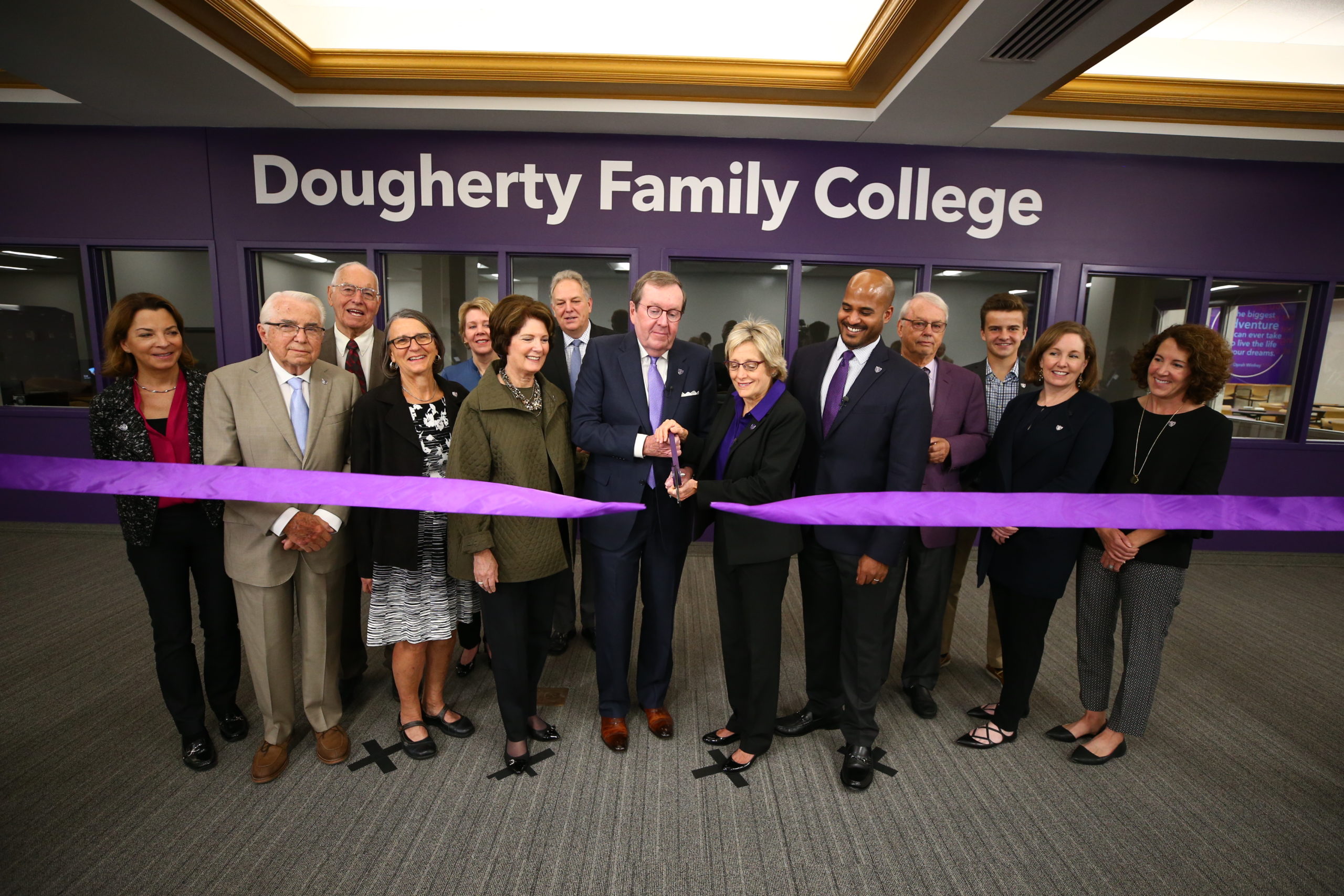 Mike Dougherty and president Julie Sullivan cut the symbolic ribbon, dedicating Dougherty Family College on Oct. 13.