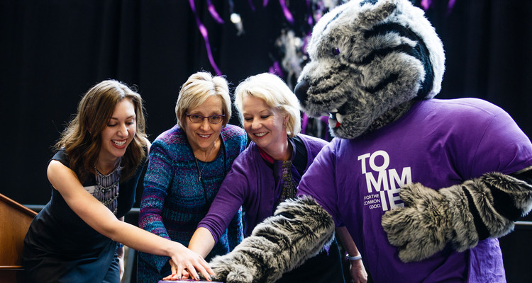 From left: Student Amanda Post, president Julie Sullivan, trustee Amy Goldman and Tommie the mascot push the button that signals the launch of streamers during a launch event for a new Student Achievement and Success initiative November 16, 2017 in the Anderson Student Center. The initiative seeks to raise $200 million for student scholarships and was kicked off by a $50 million donation by the GHR foundation.