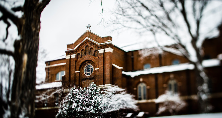 The Chapel of St. Thomas Aquinas is seen past snow-covered trees March 23, 2015.