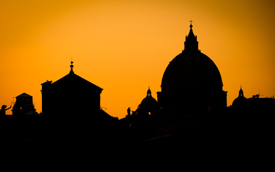The Saint Peter's Basilica is seen in silhouette on February 28, 2013, in Rome, Italy.