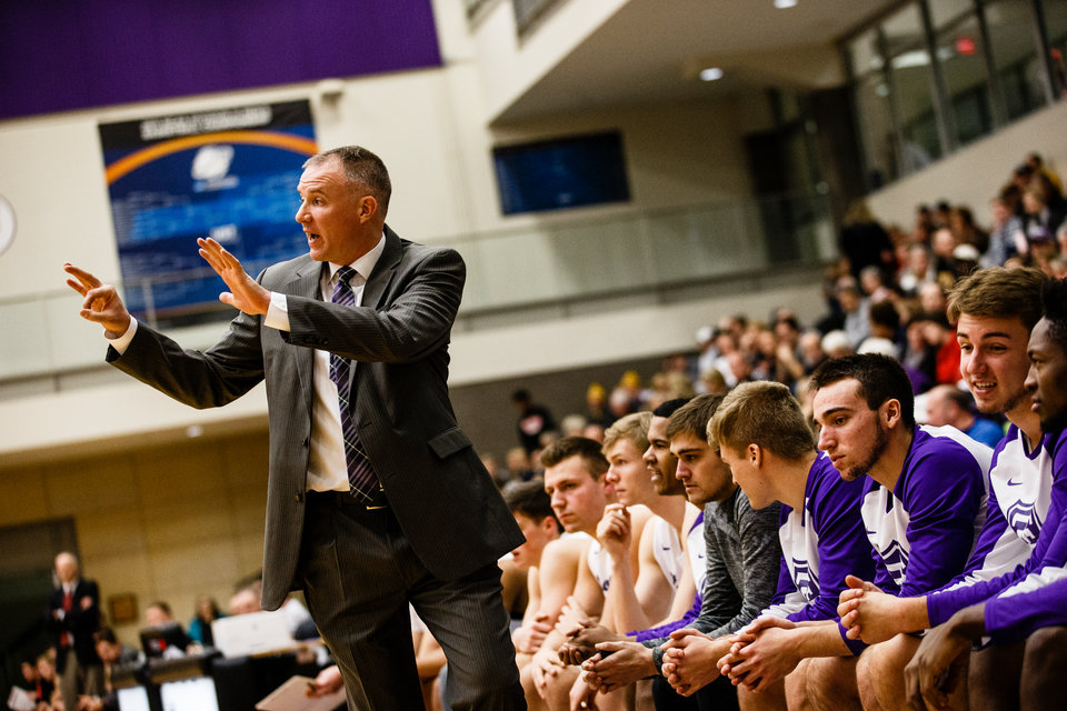 Head coach John Tauer shouts instructions to his team during a men's basketball game versus Gustavus Adolphus College December 13, 2017 in Schoenecker Arena.