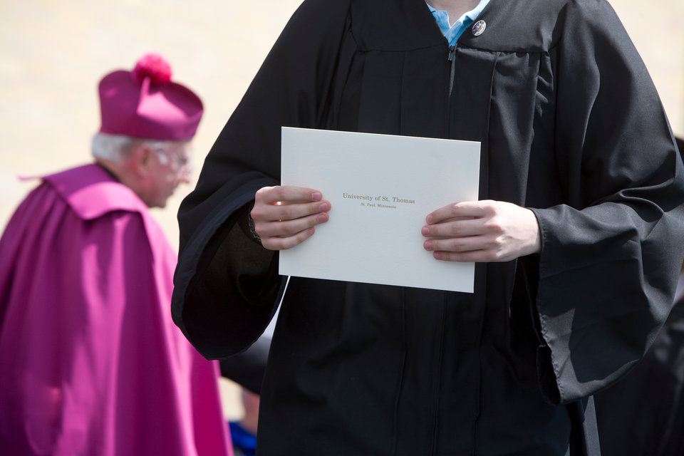 A graduating senior carries her diploma during the University of St. Thomas Undergraduate Commencement in O'Shaughnessy Stadium on Saturday, May 23, 2009.