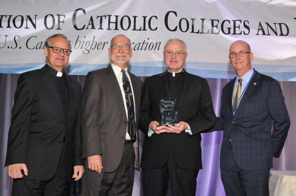 Father Dennis Dease, second from right, receives the Rev. Theodore Hesburgh Award from the Association of Catholic Colleges and Universities. To Dease’s left are Monsignor Franklyn Casale, president of St. Thomas University in Miami, and Michael Galligan-Stierle, president of the ACCU. On the right is Thomas Mengler, president of St. Mary’s University in San Antonio, new board chair of the ACCU and former University of St. Thomas School of Law dean.
