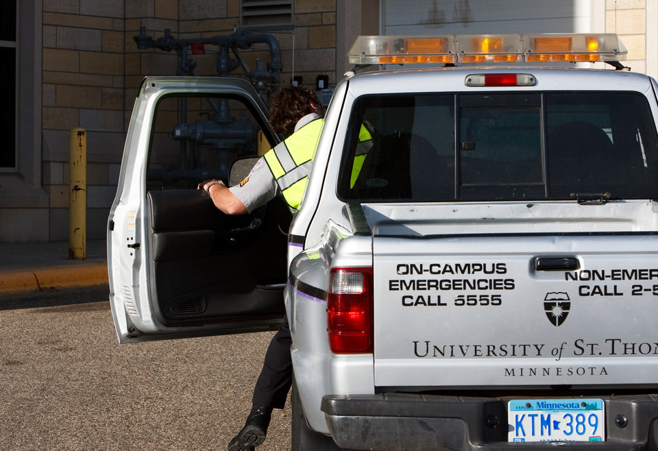 A University of St. Thomas Public Safety officer gets into a public safety vehicle on his way to assist a person who is locked out of their car on Saturday, May 23, 2009.