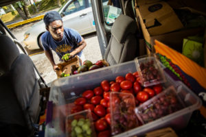 BrightSide Produce employee Steven Fuller organizes produce while making weekend deliveries to neighborhood stores for BrightSide Produce in Minneapolis on September 30, 2017. BrightSide, a project conceived at St. Thomas and run with the help of students, brings healthy food (some of which comes from the St. Thomas stewardship garden) to underserved communities.
