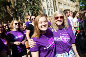 Friends smile during the 2018 March Through the Arches ceremony for graduating seniors on May 18, 2018 in St. Paul.