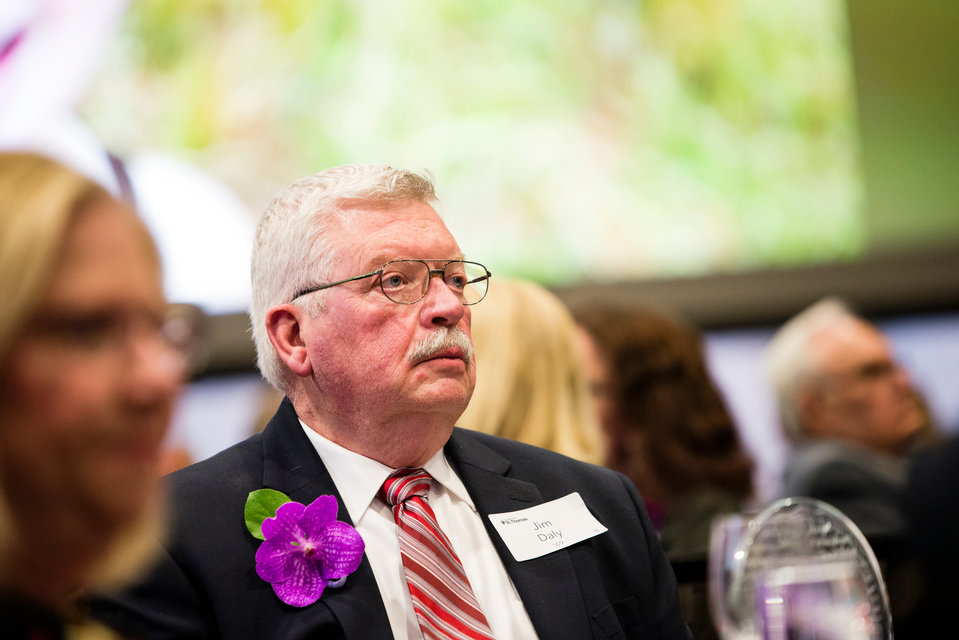 James Daly, Humanitarian award recipient, watches the celebration videos during the St.Thomas Day Dinner in the Anderson Student Center, Woulfe Alumni Hall, on Wednesday, May 2, 2018.
