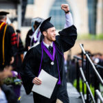 A graduating senior raises and arm in celebration after receiving his degree during the 2018 Undergraduate Commencement ceremony in O'Shaughnessy Stadium on May 18, 2018 in St. Paul.