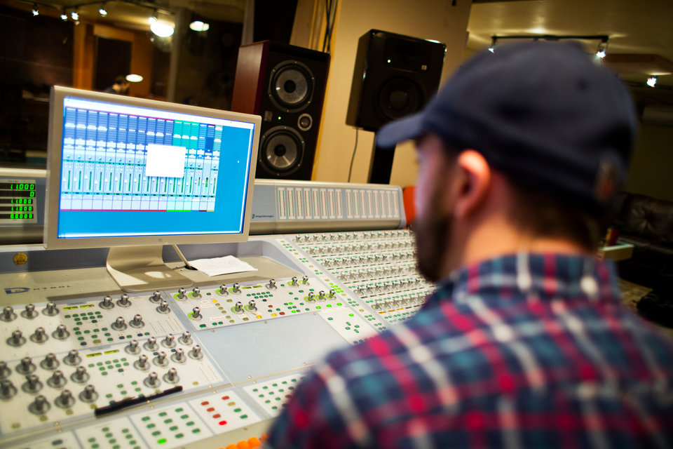 Co-instructor Bo Bodnar works at a mixing board during a music business class at Essential Sessions music studio in St. Paul on March 7, 2013.
