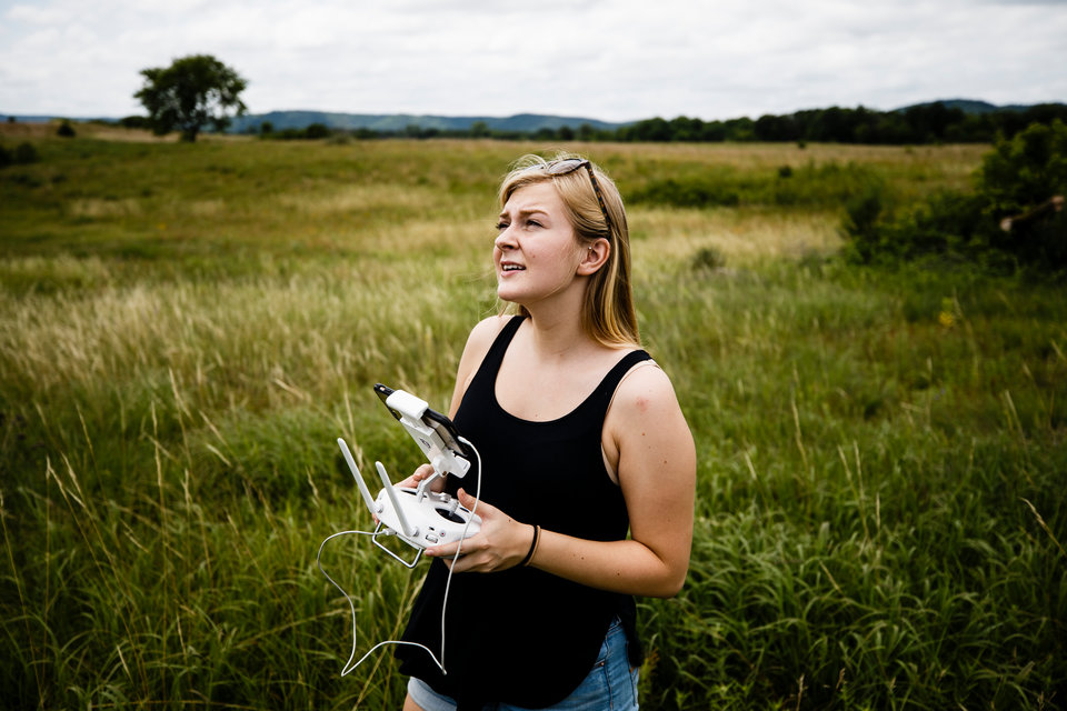 Student Alice Ready flies a drone July 10, 2017 at the Weaver Dunes near Kellogg, MN. Lorah and his students are mapping areas of the Weaver Dunes with a drone in order to study the effects of prairie restoration efforts. The research is funded in part by a sustainability grant.