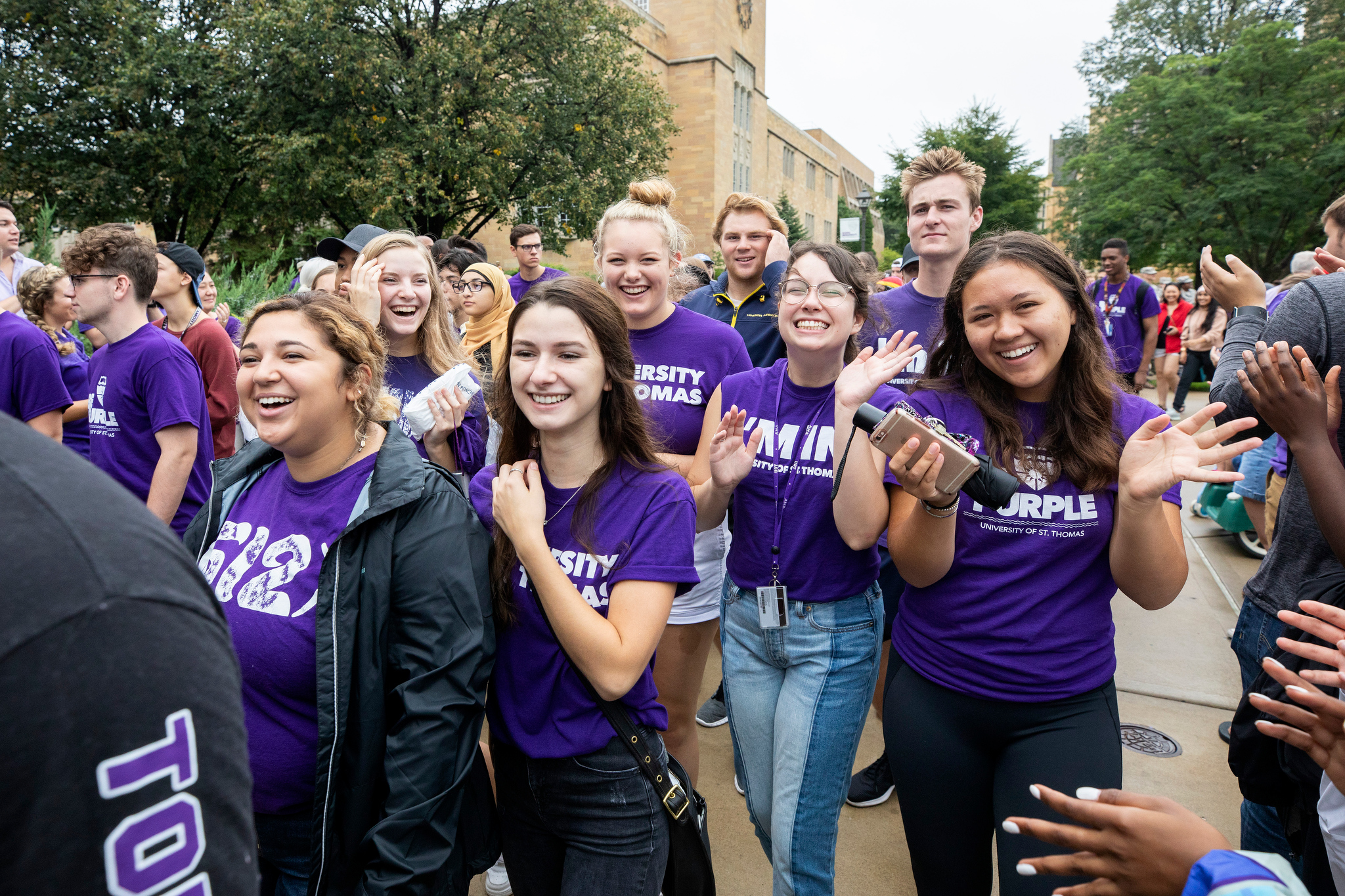 Students smile and wave at March Through the Arches on Sept. 4, 2018.