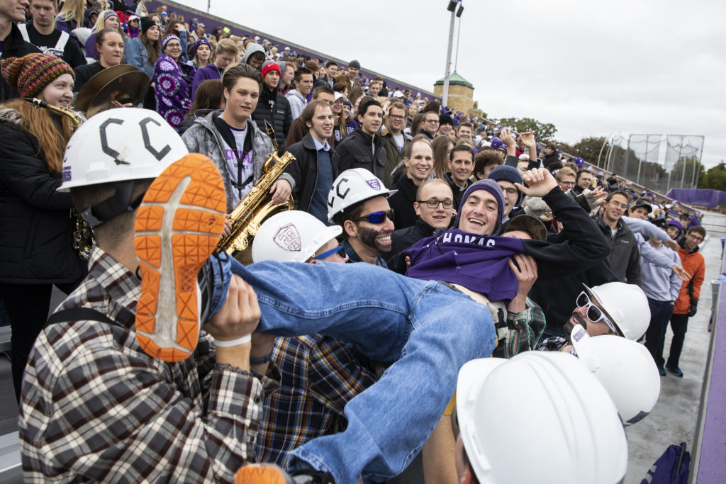 Students in Caruso's Crew celebrate a score during the homecoming game.