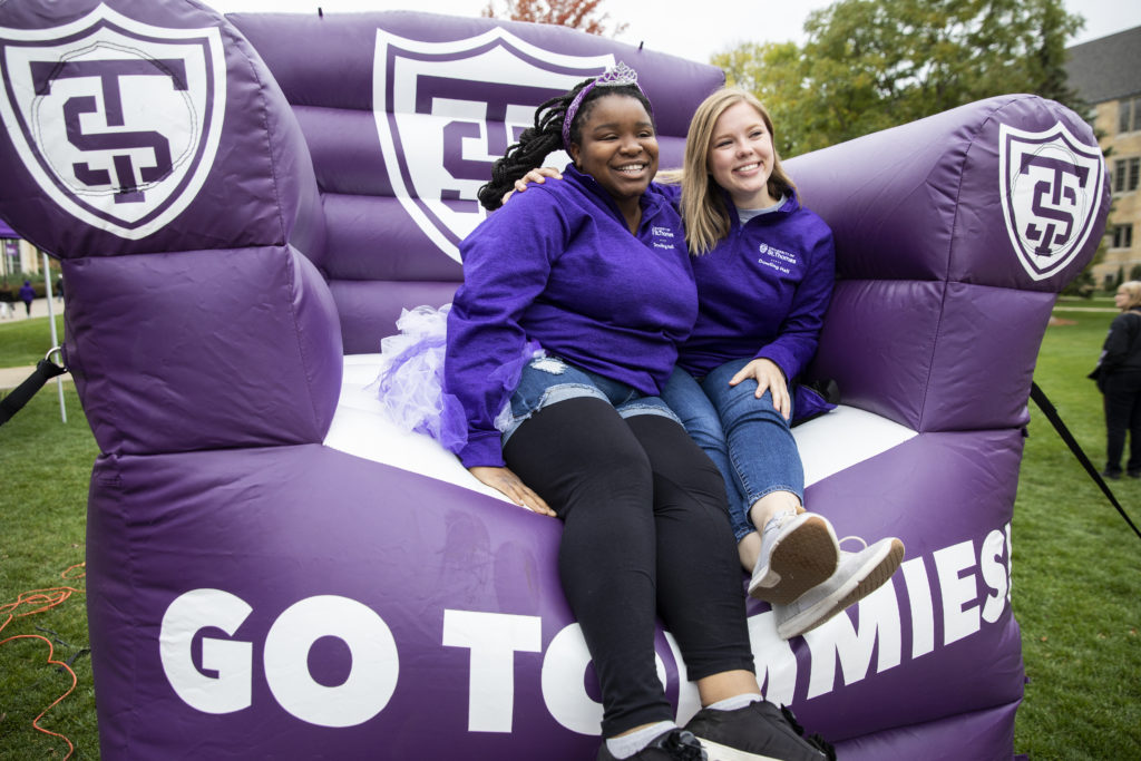 Students enjoy a stop on the big purple chair during Purple on the Plaza.