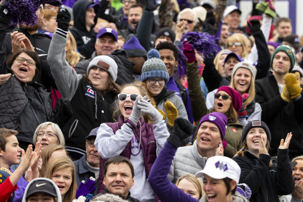 Fans celebrate the St. Thomas football team during the Homecoming game against Augsburg College.