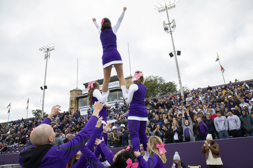 Cheerleaders keep the crowd fired up during the Homecoming game against Augsburg College.
