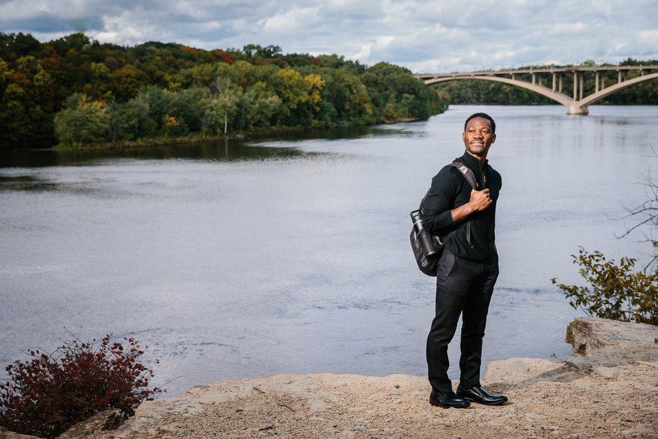 Student Victor Sikeley on the banks of the Mississippi River in St. Paul.