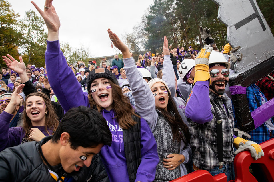 Student fans cheers from the sidelines during the Tommie Johnnie football game at Clemens Stadium in Collegeville on October 13, 2018. The University of St. Thomas fell to Saint John's University with a final score of 40-20.