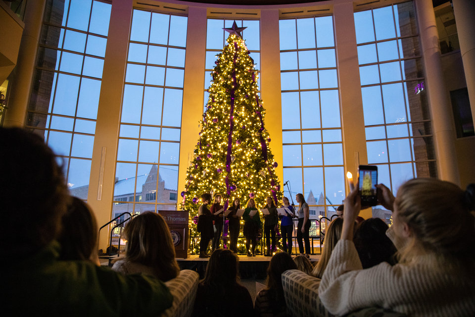 Attendees enjoy Christmas music and hold candle lights during the annual Tree Lighting Ceremony in the Anderson Student Center on December 4, 2018.