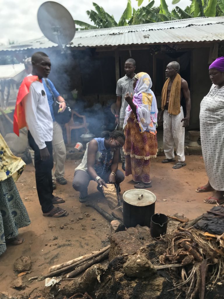 We visited a small community near Senchi where we were staying. Mustafa (the young man in the red cape) was a recipient of the Ghana Scholarship Program and we visited his father, a medicine man, at his home, which is in the background. Mustafa’s father was heating an herbal medicine when we arrived. Aida, a St. Thomas graduate student, keeps the fire going.