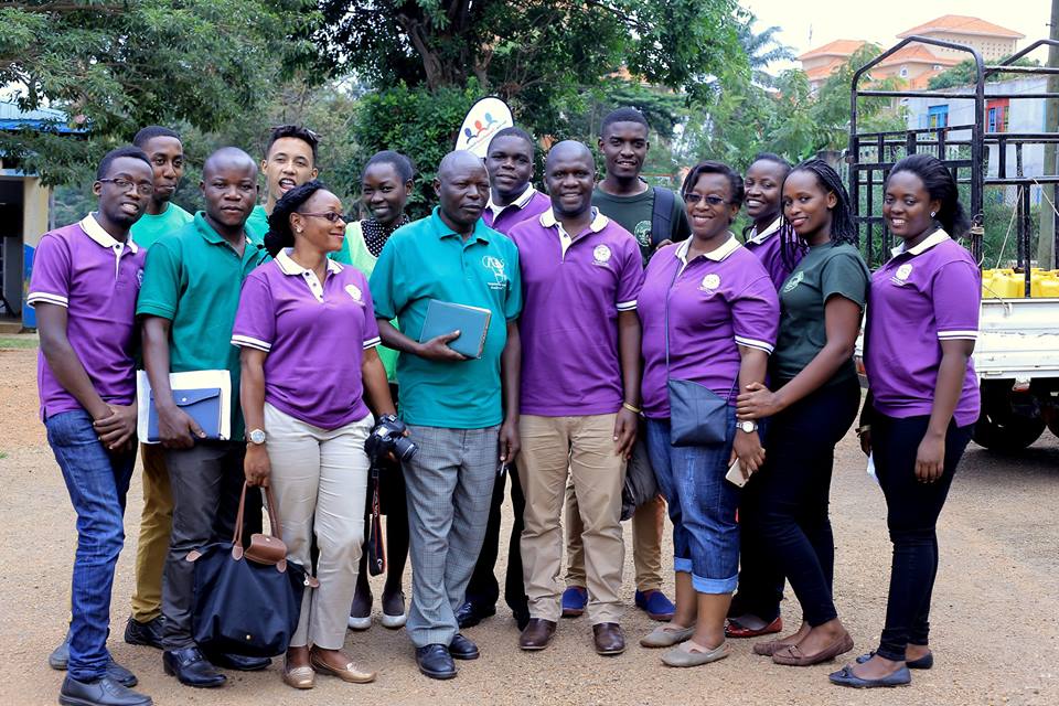 Charles Kisutu '11 (front row, fourth from left) stands in Uganda with members of the Dennis Dease Foundation.
