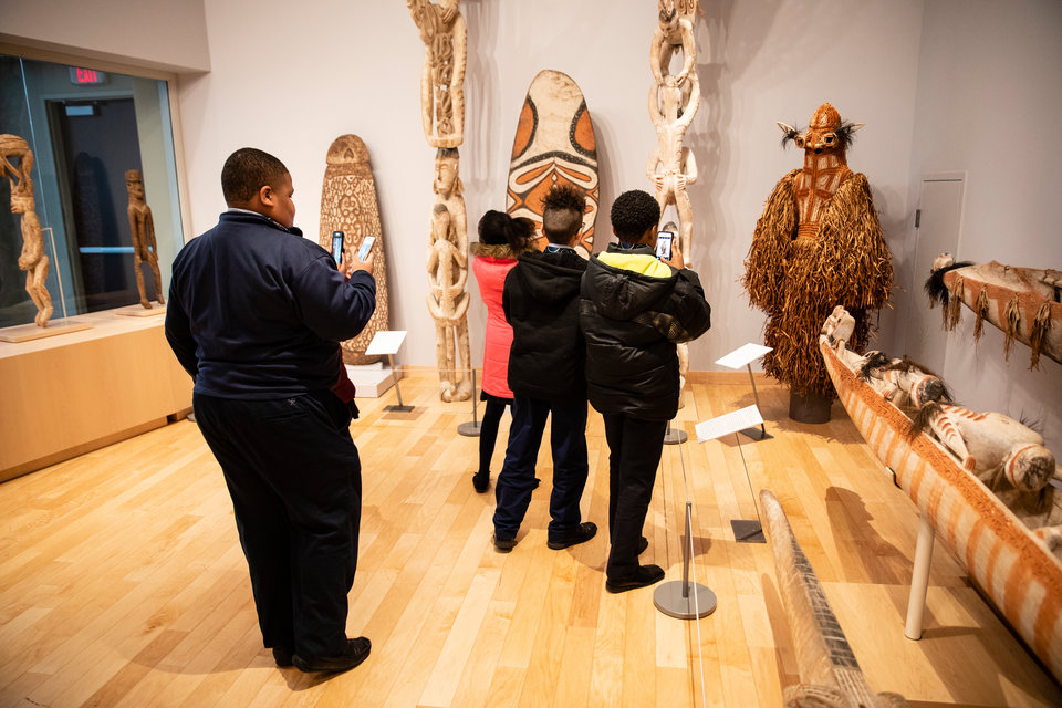 Students from St. Peter Claver Catholic School tour the American Museum of Asmat Art in the Anderson Student Center.