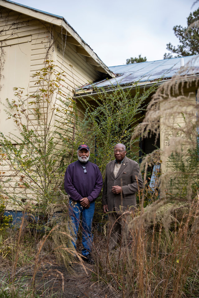 Steve Bullock, right, and his nephew Charles Bullock, 75, left, stand in front of the abandoned site of what used to be Eden Rosenwald Elementary School outside of their hometown of Enfield, North Carolina on November 23, 2018. One of few all-black schools in area growing up, this building is where Steve attended fourth, fifth and sixth grade. Steve Bullock was photographed for a feature story in St. Thomas Magazine.