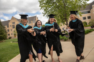 Students celebrate during the 2019 Graduate Commencement Ceremony in O’Shaughnessy Stadium on May 25, 2019 in St. Paul.