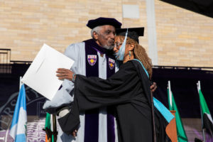 Frank Wilderson kisses his daughter on stage during the 2019 Graduate Commencement Ceremony in O’Shaughnessy Stadium on May 25, 2019 in St. Paul.