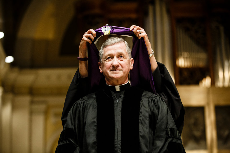 Archbishop Blase Cupich is hooded during the presentation of an honorary degree in the Chapel of St. Thomas Aquinas on May 11, 2016. Blase Cupich, Archbishop of the Diocese of Chicago, '71 (Philosophy) received an honorary degree from the University of St. Thomas.
