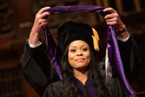 A student receives her hood during the 2019 School of Law Commencement Ceremony at Westminster Presbyterian Church in Minneapolis on May 18, 2019.