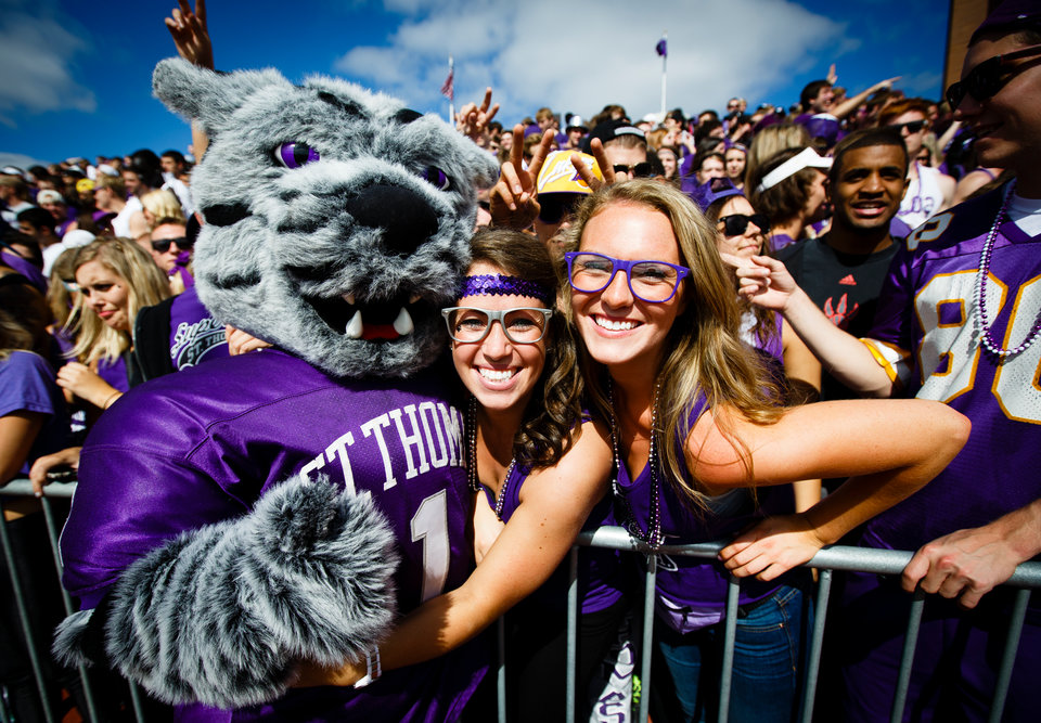 Fans pose with Tommie the mascot during the Tommie Johnnie football game Se...