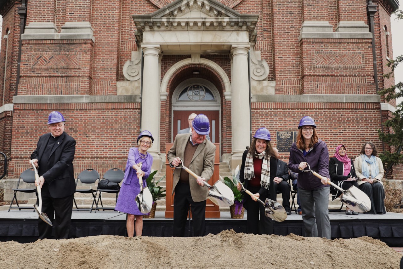 (l-r) Father Larry Snyder, President Julie Sullivan, Al and Brenda Iversen, and professor Victoria Young toss dirt at the groundbreaking ceremony for the Iversen Center for Faith and Chapel of St. Thomas Aquinas renovation.