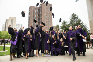 LLM international students celebrate by throwing their caps in the air after the 2019 School of Law Commencement Ceremony at the School of Law Building in Minneapolis on May 18, 2019.