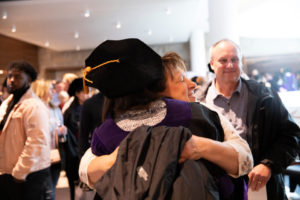 A graduating student receives a hug after the 2019 School of Law Commencement Ceremony at Westminster Presbyterian Church in Minneapolis on May 18, 2019.