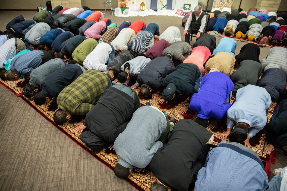 Guests participate in an evening prayer during the Ramadan Iftar dinner celebration, hosted by the Muslim Student Association and the Saudi Student Club in the James B. Woulfe Alumni Hall in the Anderson Student Center on May 8, 2019.