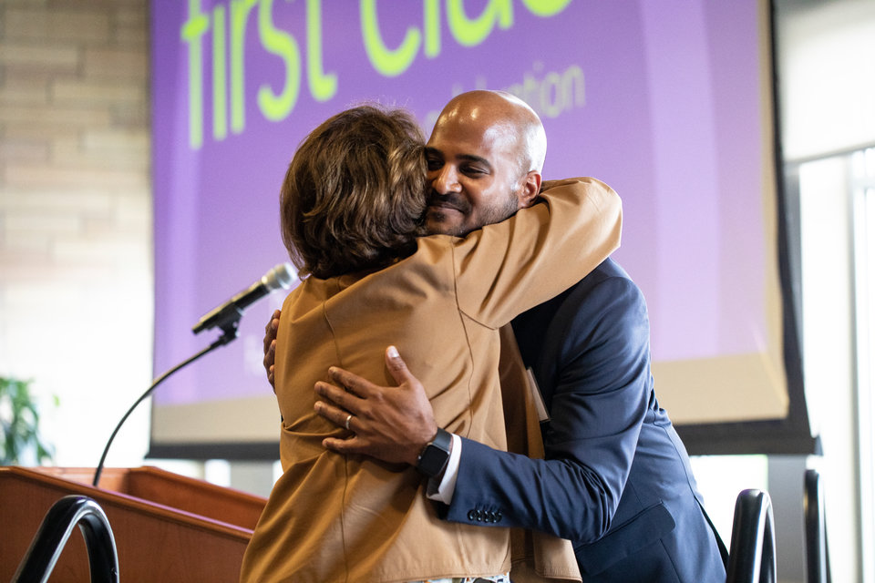 Alvin Abraham hugs Kathy Dougherty during a Dougherty Family College reception for faculty, staff, students and donors in honor of the first graduating class in Woulfe Alumni Hall on May 16, 2019, in St. Paul.