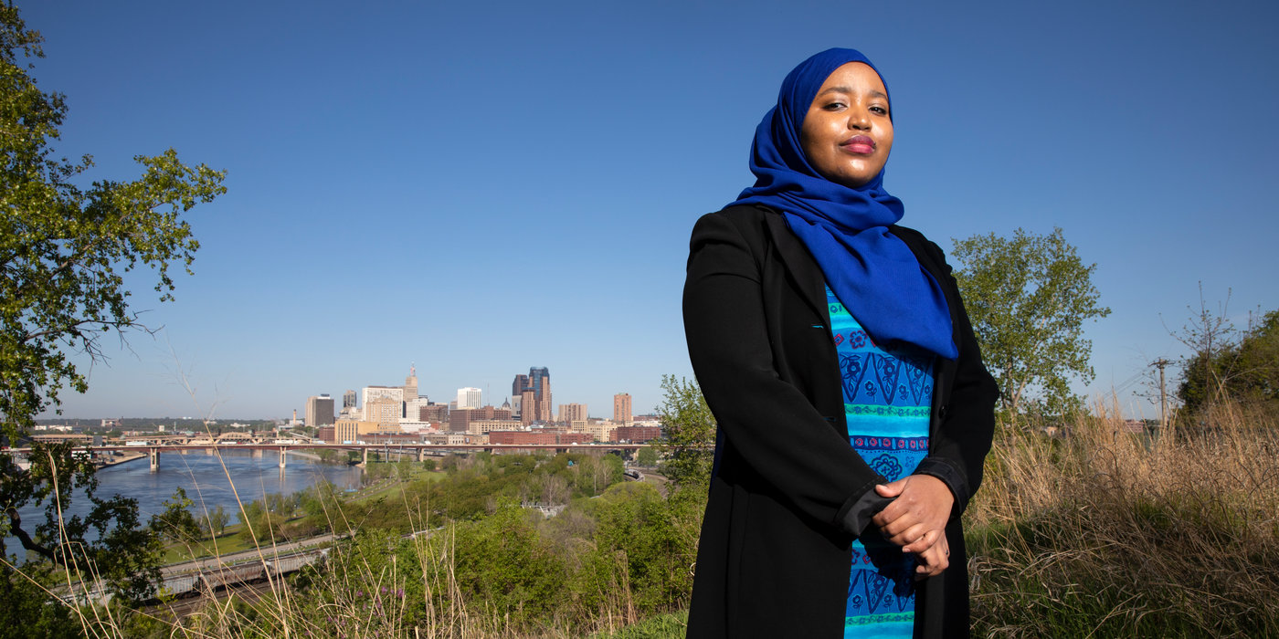 Ikram Koliso stands for a portrait at Indian Mounds Park overlooking downtown St. Paul.