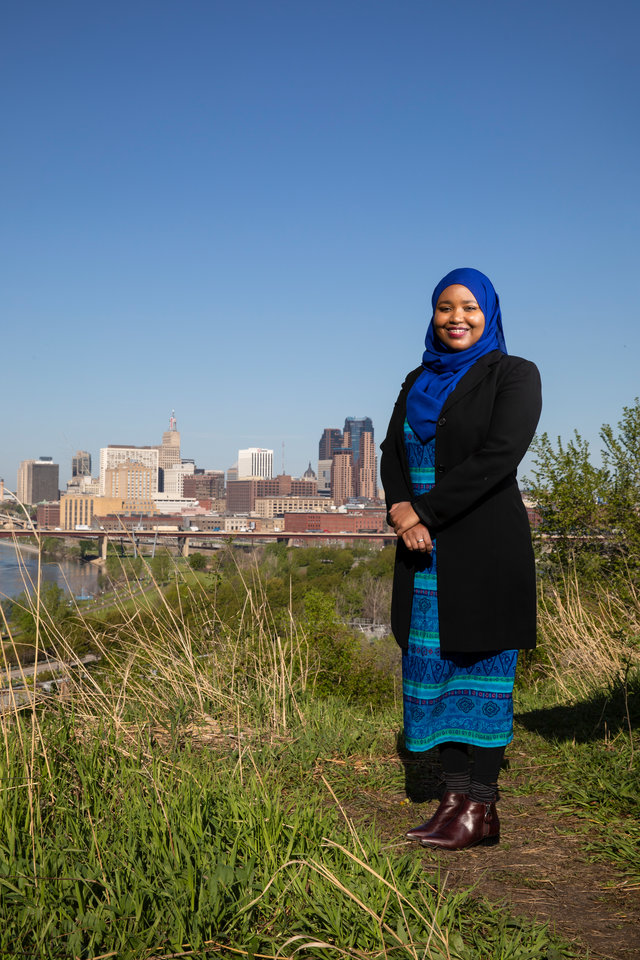 Ikram Koliso stands for a portrait at Indian Mounds Park overlooking downtown St. Paul. 