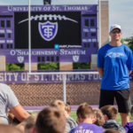 Minnesota Vikings Quarterback Kirk Cousin speaks to camp attendees during the Kirk Cousins Football Camp at Palmer Field in O’Shaughnessy Stadium.