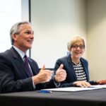 Tim Marx, president and CEO of Catholic Charities, and President Julie Sullivan during an affiliation agreement signing between the University of St. Thomas and Catholic Charities.