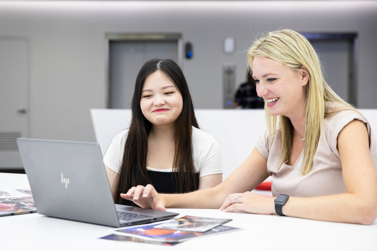 Dougherty Family College student Rose Xiong, left, sits with her supervisor Jessi Cooper, right, at the 3M headquarters, the place of Xiong’s internship.